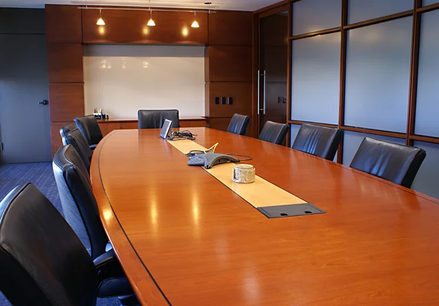 Meeting room with chairs and a white board.