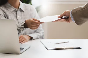 Female employee smiling when she receives salary from boss