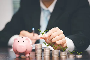 Businessman touch coins with line connect and Coins stack on the wooden table , Saving ideas and investment budget, Creative ideas concept of saving money concept